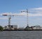 Docks with ships and cranes along the riverside of the river Lek or Noord in the Netherlands.