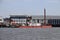 Docks with ships and cranes along the riverside of the river Lek or Noord in the Netherlands.