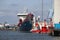 Docks with ships and cranes along the riverside of the river Lek or Noord in the Netherlands.