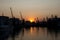 Dockside gantry crane silhouettes in Odesa seaport at sunset sky background