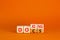 Docs or doxing symbol. Concept words Docs Doxing on wooden block. Beautiful orange table orange background. Business docs or