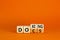 Docs or doxing symbol. Concept words Docs Doxing on wooden block. Beautiful orange table orange background. Business docs or