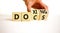 Docs or doxing symbol. Concept words Docs Doxing on wooden block. Beautiful white table white background. Businessman hand.