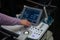 Doctor adjusts ultrasound scan equipment for sonography diagnostics