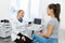 Doctor advises the patient`s girl after an ultrasound diagnosis. indicates with a pen on the monitor of the ultrasound machine th