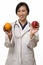 Doctor with apple and orange