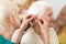 Doctor applying hearing aid to senior woman`s ear