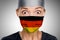 Doctor Asian woman shocked German doctor for COVID-19 crisis help with Germany flag on surgical mask. Healthcare workers