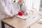 Doctor asian woman sitting and working on desk using plastic brain model and hands pointing or writing note together at hospital