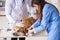 Doctor and assistant checking up golden retriever dog in vet cli