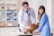 Doctor and assistant checking up golden retriever dog in vet cli