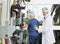 Doctor Assisting Senior Man To Use Exercise Machine