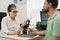 Doctor Audiologist consulting patient about hearing aids at clinic