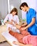 Doctor bandaging patient in hospital.