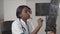 Doctor beautiful african american healthcare worker with x-ray, medical international concept, black doctor thinking