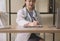 Doctor beautiful asian woman sitting and working on desk using labtop and writing note at hospital,Close up and selective focus ha