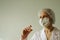 Doctor biologist in a protective mask holds in his hands a syringe and a vaccine against coronavirus covid19.