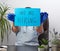 Doctor in a blue coat, sterile medical gloves holds a poster with the inscription we are hiring