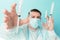 Doctor in blue face mask catches flying syringes. Thinking about vaccine for covid-19 coronavirus, flu, infectious diseases.Mass
