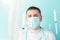 Doctor in blue face mask catches flying syringes. Thinking about vaccine for covid-19 coronavirus, flu, infectious diseases.Mass