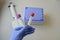 A doctor in a blue glove holds in his hand two test tubes for performing analyzes with multi-colored caps. against the background