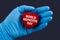 Doctor in blue gloves holds a heart with text World hepatitis day, concept
