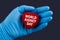 Doctor in blue gloves holds a heart with text World Kidney Day, concept