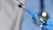 Doctor in blue latex gloves fill in syringe with vaccine from glass vial, closeup