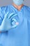 Doctor in blue latex gloves holding a large round pill