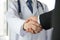 Doctor and businessman shaking hands