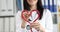 Doctor cardiologist makes stethoscope heart sign closeup
