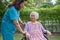 Doctor caregiver help and care Asian senior or elderly old lady woman patient sitting on wheelchair at nursing hospital ward,