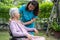 Doctor caregiver help and care Asian senior or elderly old lady woman patient sitting on wheelchair in park at nursing hospital,