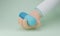 Doctor cartoon hand holds a PAXLOVID capsule antiviral drug pill for anti Corona virus(COVID-19) pastel concept,Isolate background