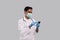 Doctor Chatting on Phone Wearing Medical Mask and Gloves. Indian Man Doctor with Phone Isolated