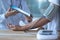 Doctor checking blood pressure of older patient via tablet on hands in hospital