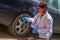 Doctor checking a car with a stethoscope as a symbol of curing a car