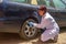 Doctor checking a car with a stethoscope as a symbol of curing a car