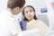 Doctor checking girl patient at dental clinic