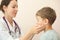 Doctor checks little boy lymph nodes