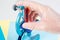 Doctor chemist man hand in  protective gloves hold test tube coronavirus closeup microscope background