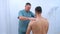 Doctor chiropractor treats patient`s hands in clinic on rehabilitation therapy.