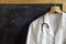 Doctor coat with stethoscope on blackboard