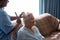 Doctor combing hair of patient in nursing home