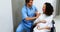 Doctor comforting pregnant woman in corridor