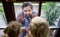 Doctor coming to see children in isolation, window glass separating them.