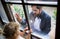 Doctor coming to see daughter in isolation, window glass separating them.