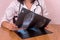 Doctor comparing patient`s x-rays on wooden table