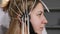 Doctor connecting electronic sensors with wires to female patient. Young woman wired to EEG machine or