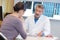 Doctor in consultation with woman grave expression